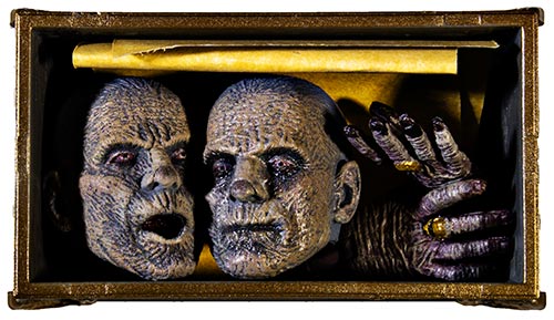 Mummy heads and hands in a box
